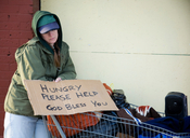 Image of homeless female with hungry sign