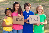 Image of 4 children holding a Thank You sign