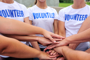 Image of volunteer team with their hands stacked